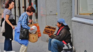 People helping homeless man.